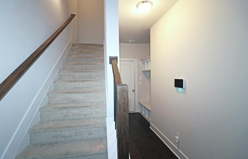 2163 Wiggins Walk Atlanta, GA 30316 - Photo 16 of 22 a view of staircase with white walls and empty racks