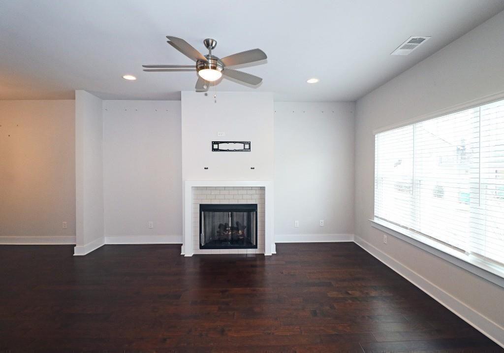 2163 Wiggins Walk Atlanta, GA 30316 - Photo 3 of 22 a view of a livingroom with a fireplace a ceiling fan and wooden floor