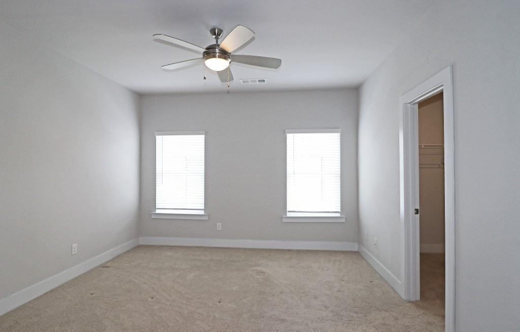 2163 Wiggins Walk Atlanta, GA 30316 - Photo 8 of 22 an empty room with windows and chandelier fan