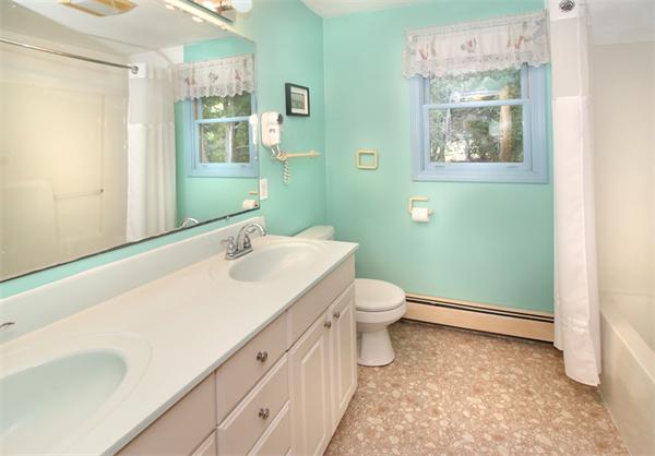 14 Samoset Road Woburn, MA 01801 - Photo 19 of 25 a bathroom with a toilet sink and a mirror