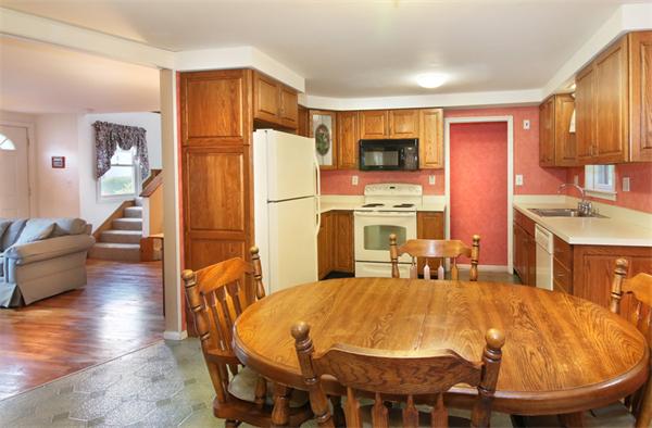 14 Samoset Road Woburn, MA 01801 - Photo 7 of 25 a dining table chair next to a window with the kitchen view