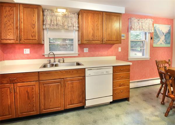 14 Samoset Road Woburn, MA 01801 - Photo 8 of 25 a kitchen with granite countertop a sink cabinets and window