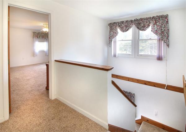 14 Samoset Road Woburn, MA 01801 - Photo 10 of 25 a view of a hallway with wooden floor and staircase