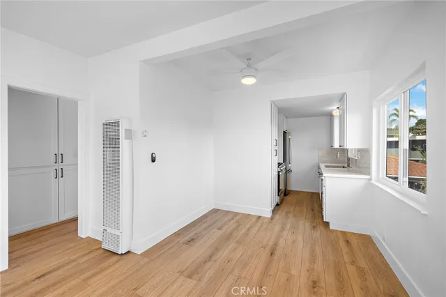a view of a kitchen with wooden floor and a sink