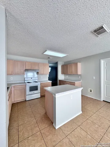 a kitchen with a cabinets and white appliances