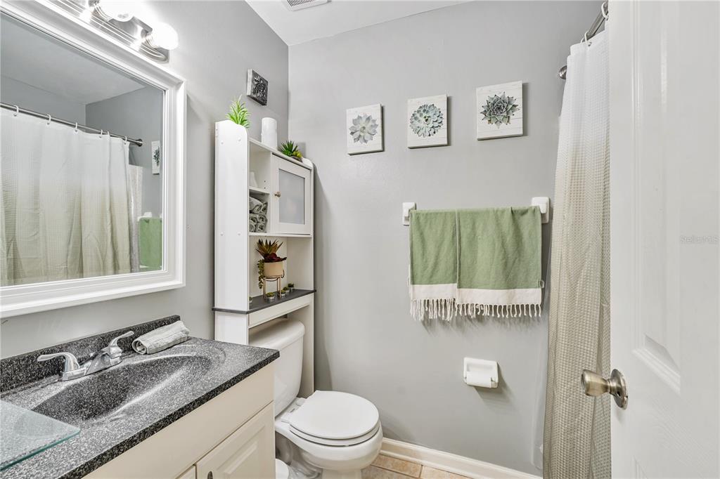 701 St Michael Lane Altamonte Springs, FL 32714 - Photo 14 of 19 a bathroom with a granite countertop toilet sink and mirror