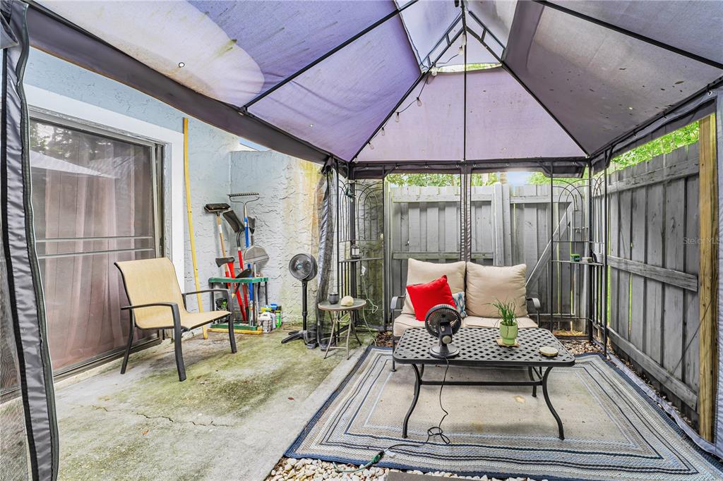 701 St Michael Lane Altamonte Springs, FL 32714 - Photo 16 of 19 a patio with glass table and chairs
