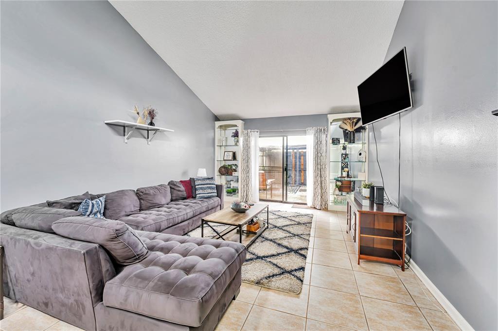 701 St Michael Lane Altamonte Springs, FL 32714 - Photo 3 of 19 a living room with furniture and a flat screen tv