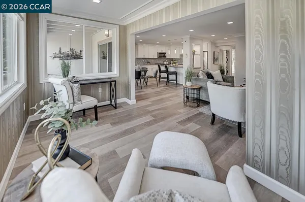 a living room with furniture and wooden floor