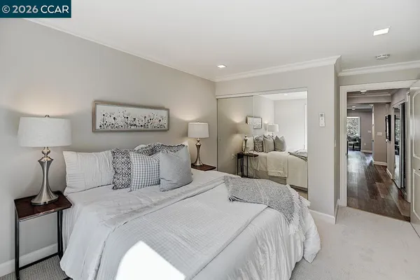 a bedroom with a bed and a lamp