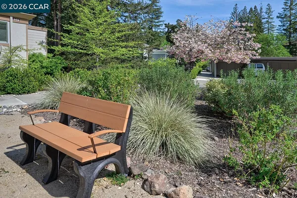 an aerial view of a wooden chairs and table in a backyard