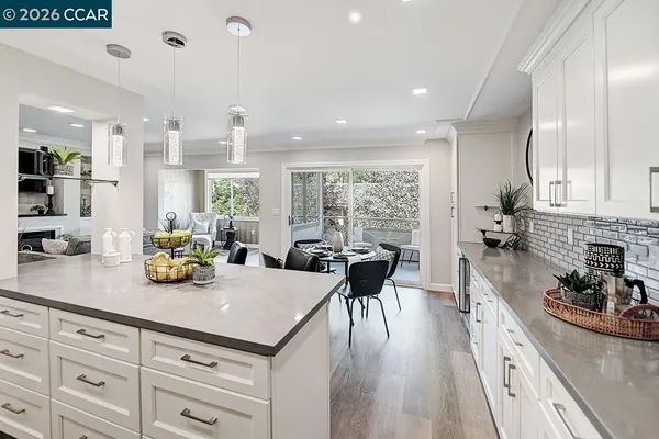a kitchen with stainless steel appliances granite countertop stove top oven and cabinets