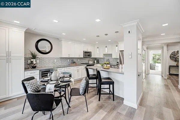 a view of a dining room with furniture and a kitchen