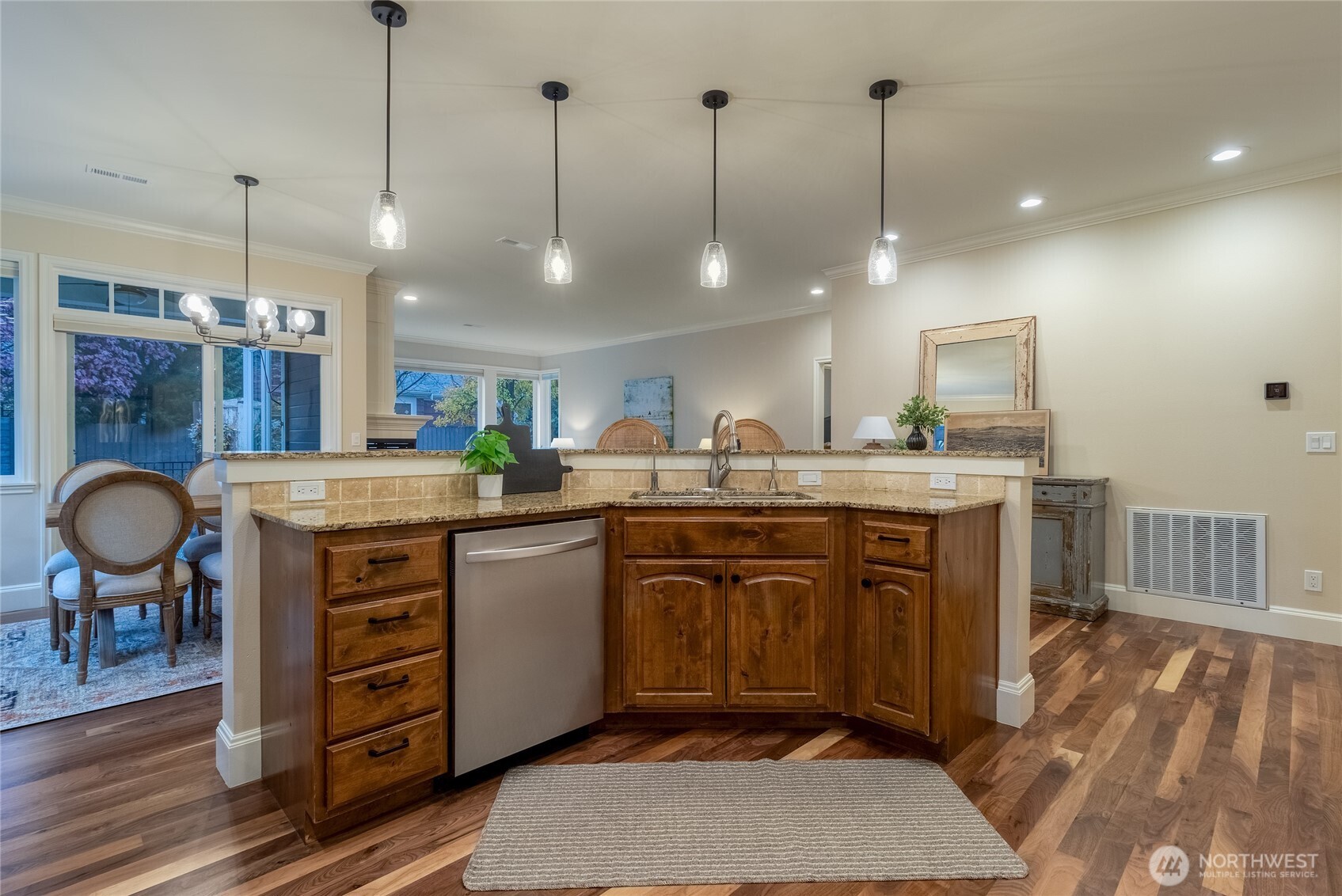 711 Southeast Pheasant Run College Place, WA 99324 - Photo 11 of 40 a kitchen with kitchen island a sink a stove a dining table and chairs