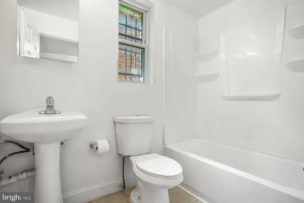a bathroom with a sink toilet and bathtub