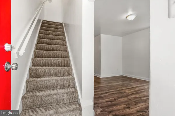 a view of an empty room with stairs