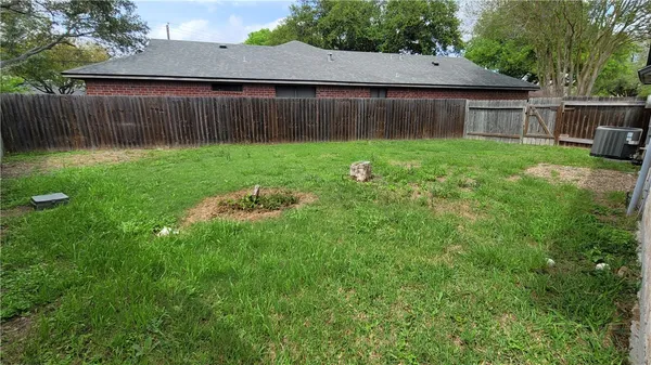a view of backyard with tub and trees
