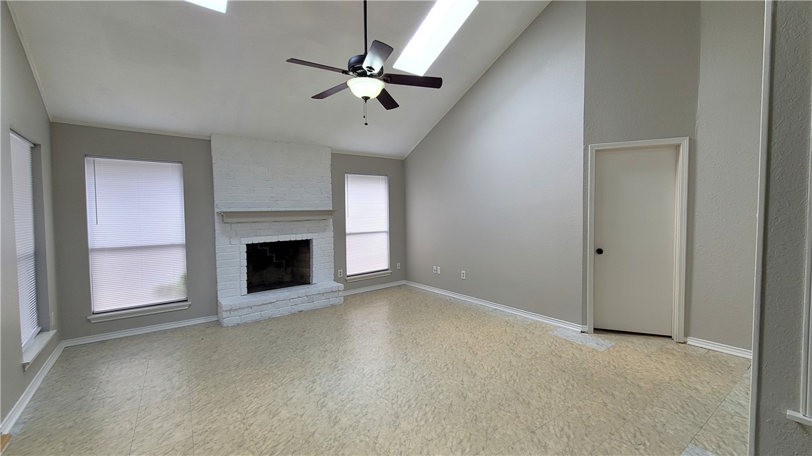 6925 Fawn Ridge Drive Corpus Christi, TX 78413 - Photo 4 of 16 an empty room with fireplace and fan