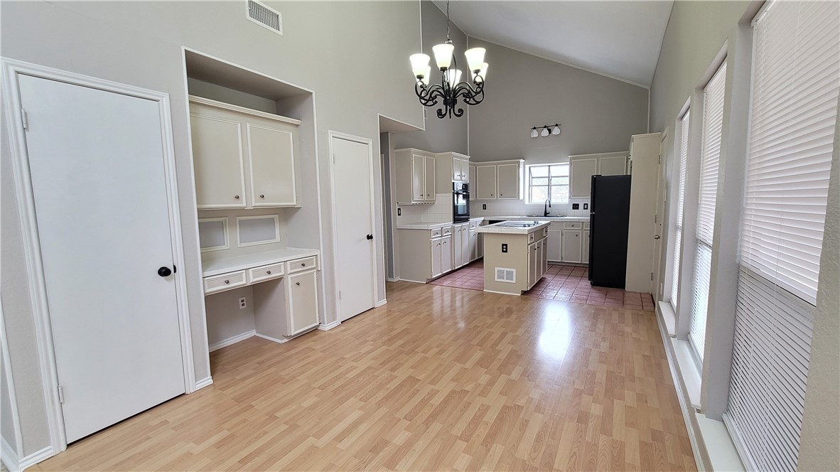 6925 Fawn Ridge Drive Corpus Christi, TX 78413 - Photo 5 of 16 a kitchen with a refrigerator and wooden floor