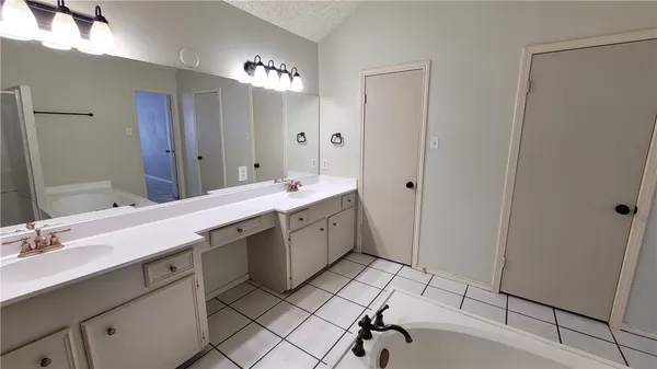 a spacious bathroom with a double vanity sink mirror and toilet