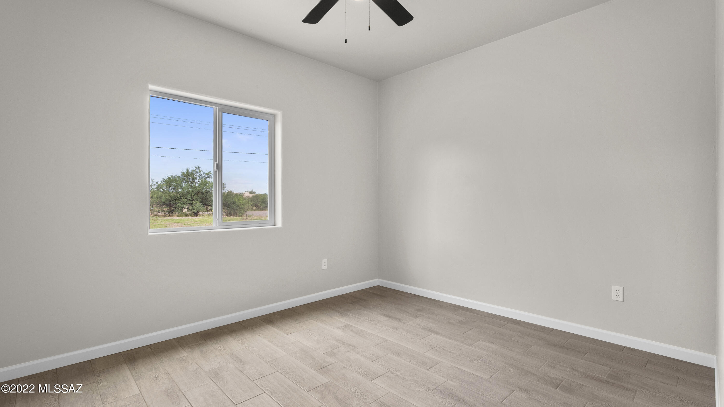 1843 Calle Mulata Rio Rico, AZ 85648 - Photo 19 of 27 an empty room with a window and a ceiling fan