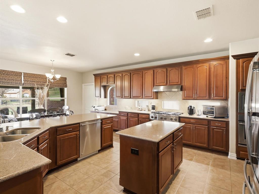 1130 Rio Bravo Way Shady Shores, TX 76208 - Photo 11 of 40 a kitchen with a sink stove top oven and cabinets
