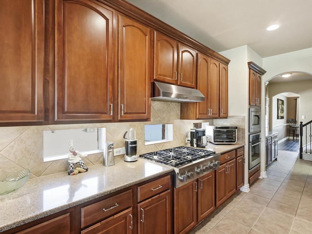 1130 Rio Bravo Way Shady Shores, TX 76208 - Photo 12 of 40 a kitchen with stainless steel appliances granite countertop a sink stove and cabinets