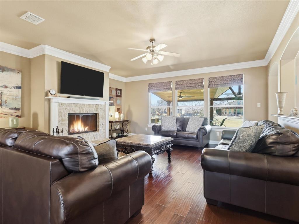 1130 Rio Bravo Way Shady Shores, TX 76208 - Photo 14 of 40 a living room with furniture a flat screen tv and a fireplace