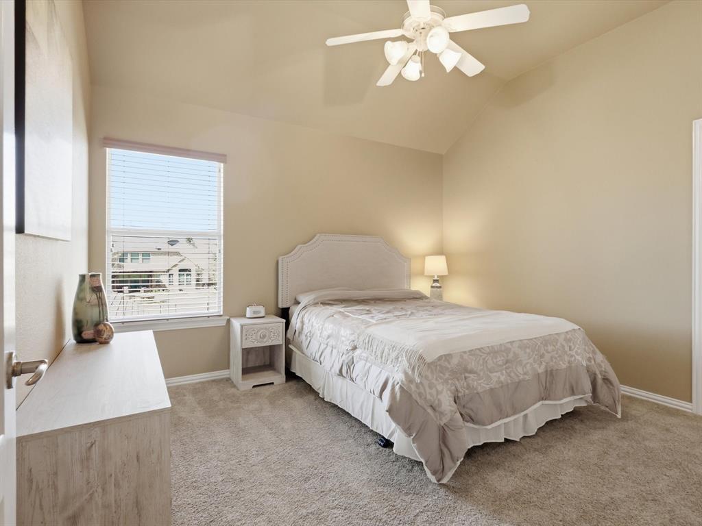 1130 Rio Bravo Way Shady Shores, TX 76208 - Photo 23 of 40 a bedroom with a bed and a chandelier