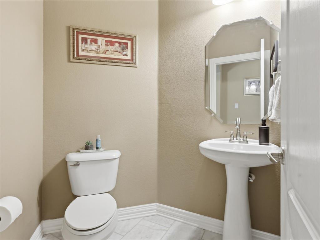 1130 Rio Bravo Way Shady Shores, TX 76208 - Photo 27 of 40 a bathroom with a toilet a sink and mirror