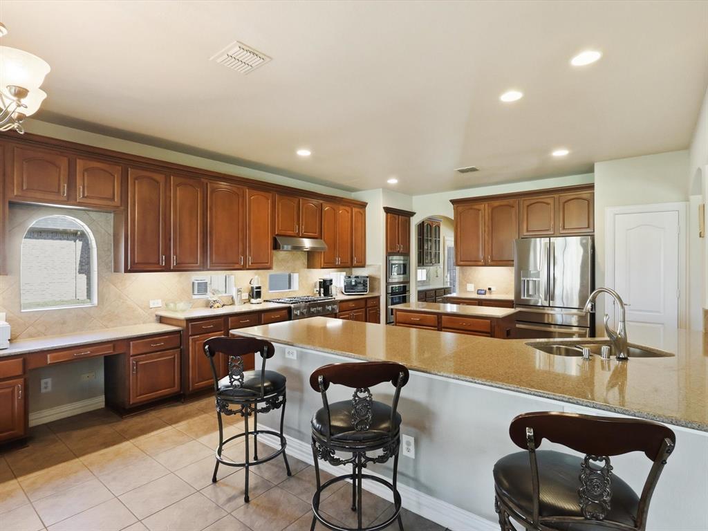 1130 Rio Bravo Way Shady Shores, TX 76208 - Photo 8 of 40 a kitchen with counter top space cabinets and stainless steel appliances