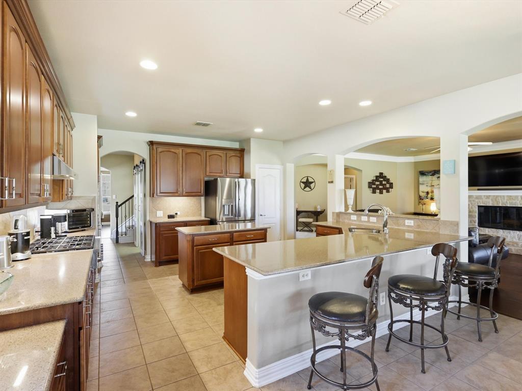 1130 Rio Bravo Way Shady Shores, TX 76208 - Photo 9 of 40 a large kitchen with a table and chairs in it