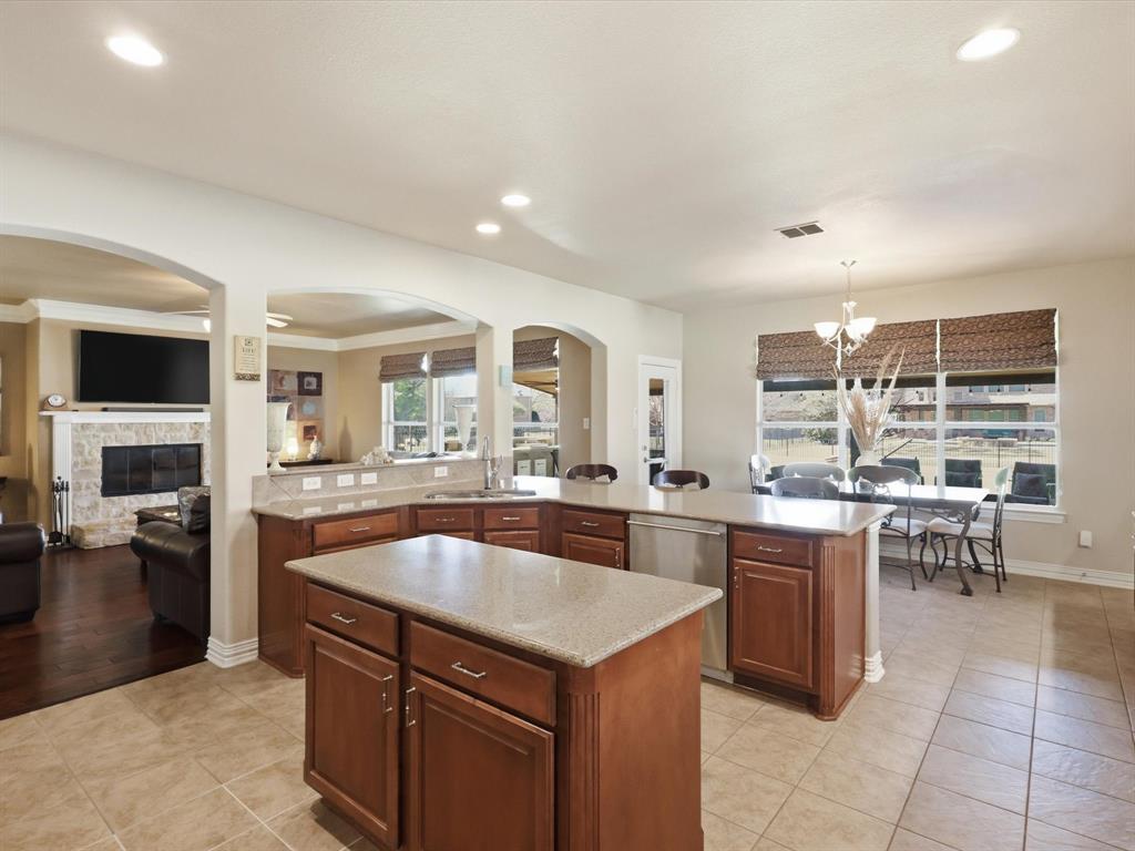 1130 Rio Bravo Way Shady Shores, TX 76208 - Photo 10 of 40 a large kitchen with kitchen island a sink a counter space and living room view