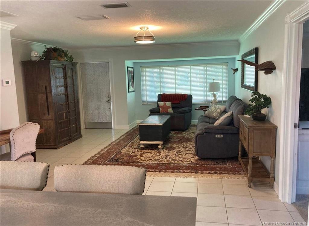 4621 Southeast Shady Ridge Lane Stuart, FL 34997 - Photo 3 of 11 a living room with furniture and a window