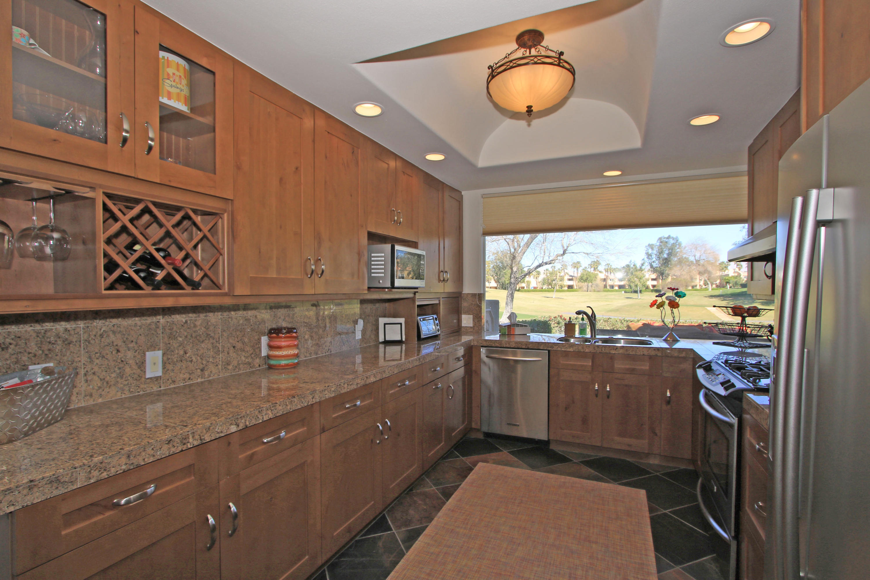 36 Pine Valley Drive Rancho Mirage, CA 92270 - Photo 13 of 57 a kitchen with stainless steel appliances granite countertop a stove a sink and a refrigerator