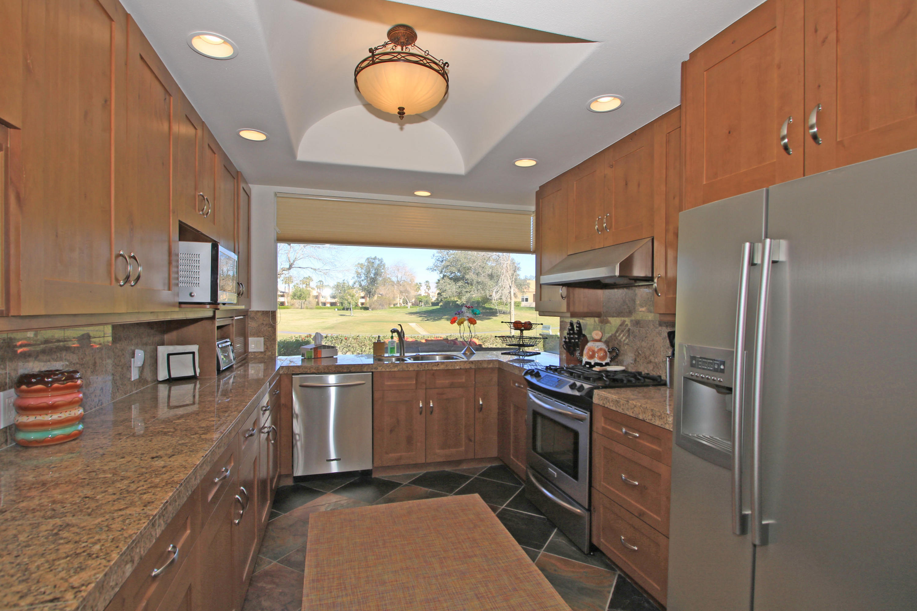 36 Pine Valley Drive Rancho Mirage, CA 92270 - Photo 14 of 57 a kitchen with lots of counter top space appliances and cabinets