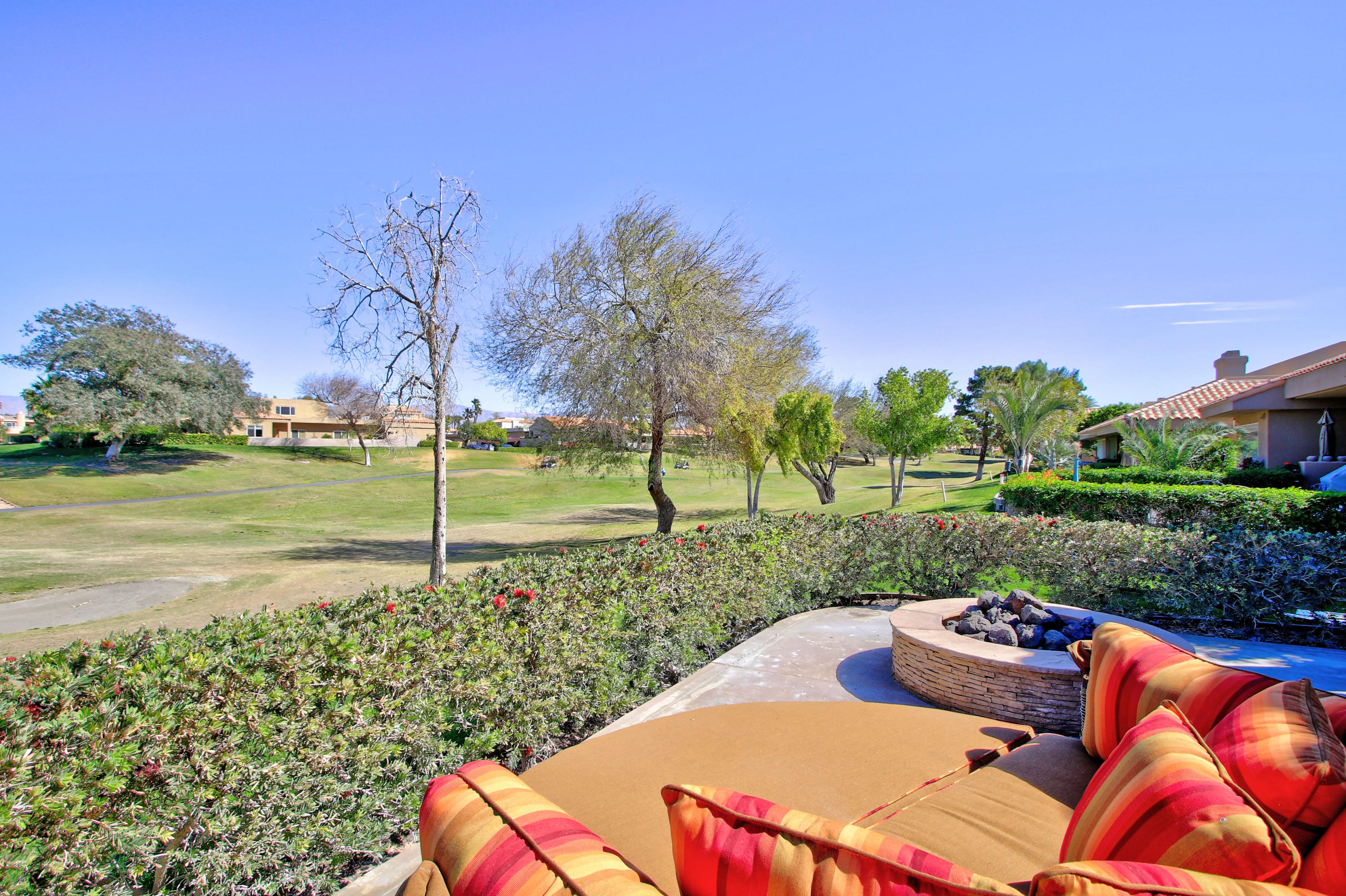 36 Pine Valley Drive Rancho Mirage, CA 92270 - Photo 31 of 57 a view of a backyard with table and chairs plants and trees