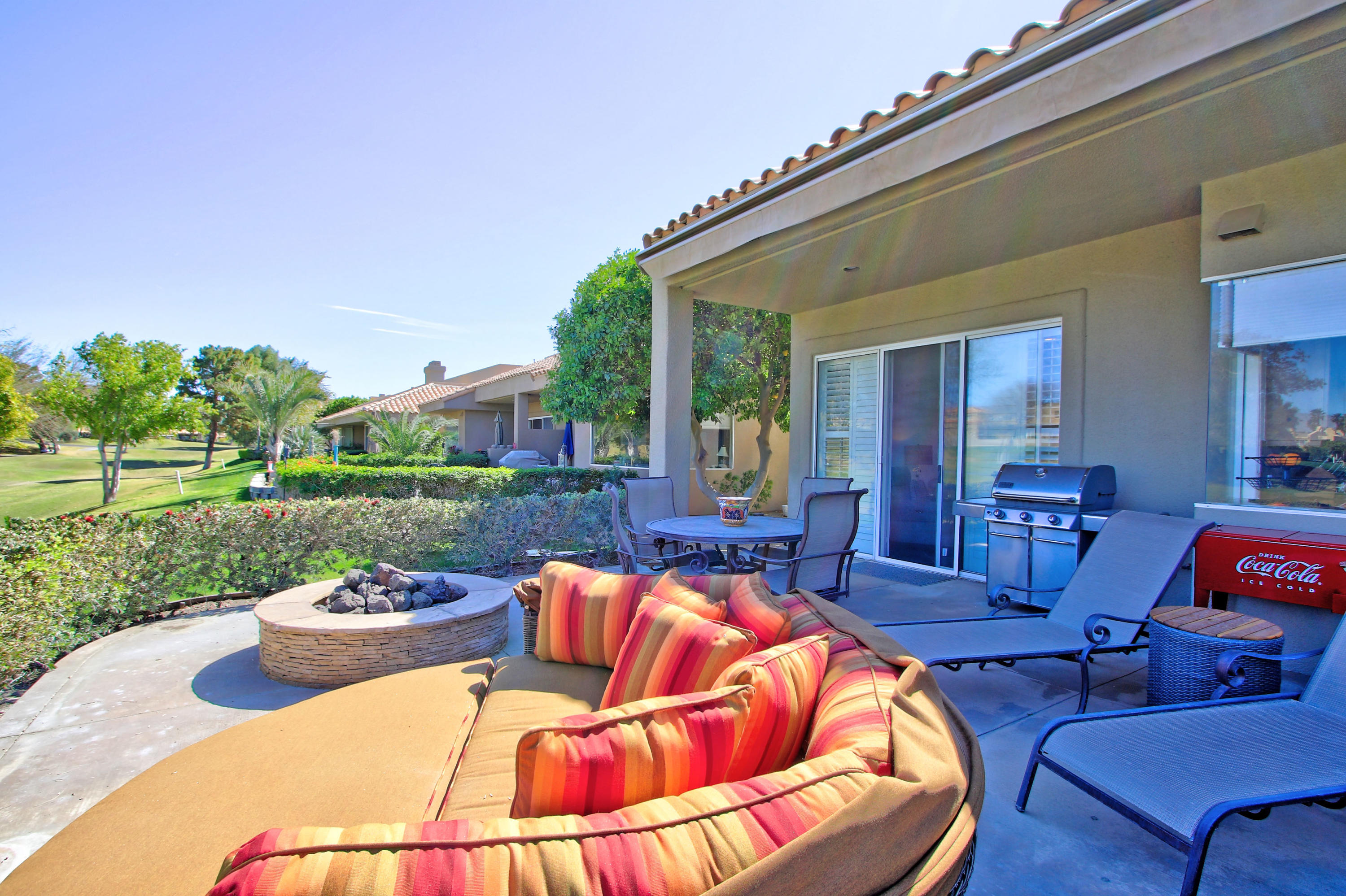 36 Pine Valley Drive Rancho Mirage, CA 92270 - Photo 41 of 57 a view of a patio with couches chairs and a big yard