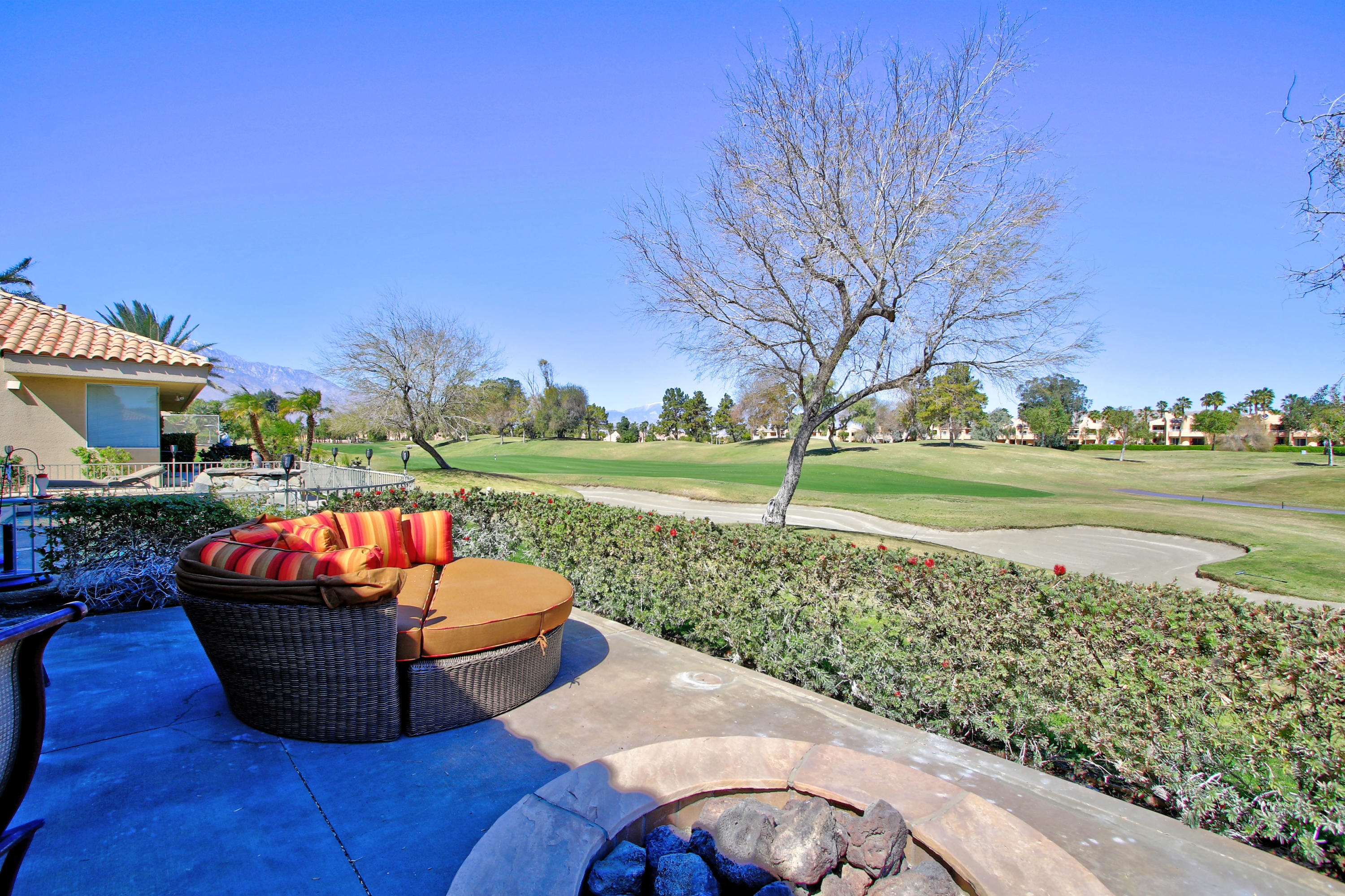 36 Pine Valley Drive Rancho Mirage, CA 92270 - Photo 42 of 57 a backyard of a house with a yard and outdoor seating