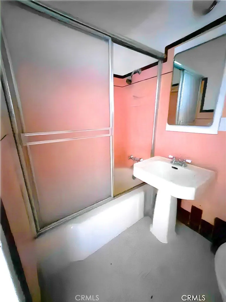 140 Linden Avenue Long Beach, CA 90802 - Photo 7 of 7 a bathroom with a sink a mirror and a shower