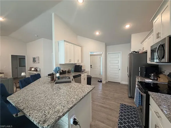 a kitchen with sink stove and refrigerator
