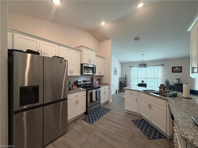 a kitchen with stainless steel appliances a refrigerator sink and stove