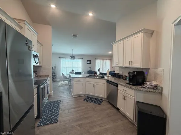 a kitchen with a sink stainless steel appliances and cabinets