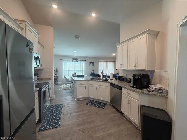 a kitchen with a sink stainless steel appliances and cabinets