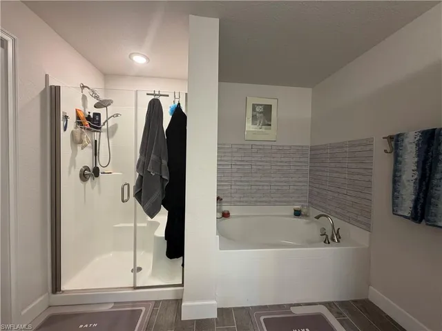 a bathroom with a bathtub and a shower