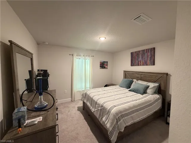 a bedroom with a bed and gym equipment
