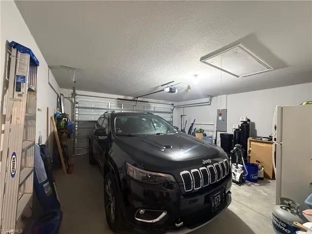 a living room with patio furniture and a floor to ceiling window