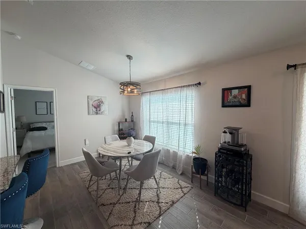 a dining room with furniture and window