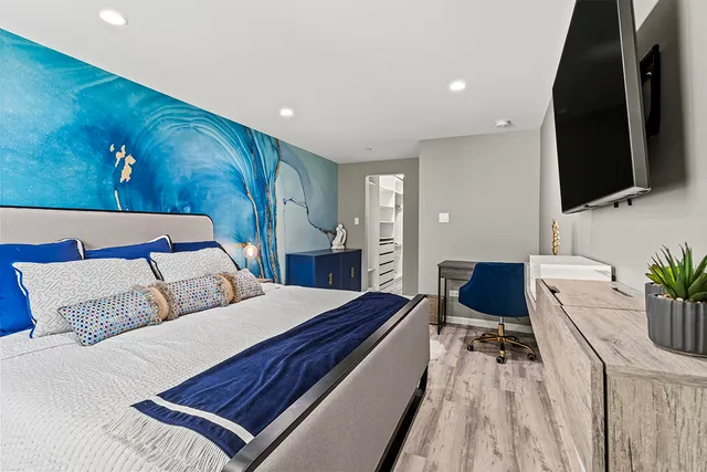 a bedroom with a large bed and a window