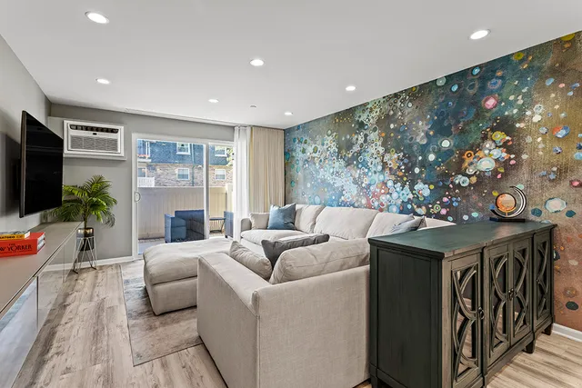 a living room with furniture and a chandelier